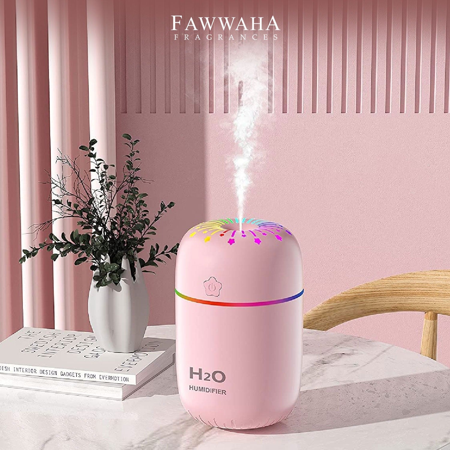 Pink H2O humidifier releasing mist on table with plant and books in pink room best humidifiers in Pakistan cool mist and air humidifiers for room use